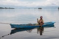 Fisherman in a small boat with his traps on the biggest lake in