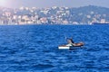 Fisherman on a small boat in the sea.