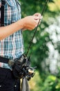 Fisherman with spinning rod on the summer lake. fisherman with spinning in his hands catching fish at sun day. Fisherman Royalty Free Stock Photo