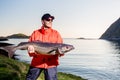 Fisherman sportsman trophy in his hands. big fish. Evening. Norw