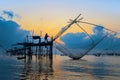 Fisherman at square dip net and colorful sky at Pakpra, phattalu Royalty Free Stock Photo