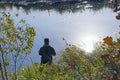 Fisherman standing on riverside and trying to catch fish. Male hobby. Recreation