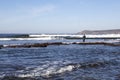 A fisherman standing in the sea while fishing