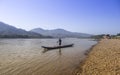 Fisherman standing on wooden boat working on his fishing net on Mae Khong river in northern Thailand Royalty Free Stock Photo