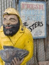 Fisherman statue and seafood sign