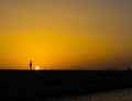 Fisherman at sunset in Alimos marina in Athens, Greece Royalty Free Stock Photo