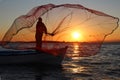 Fisherman throwing the fishing net on sunset Royalty Free Stock Photo