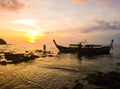 Fisherman with Sunset and Boat at Koh Bulone island, Satun Thailand Royalty Free Stock Photo