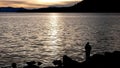 A fisherman at sunset at Lake Tahoe, Nevada in Incline village Royalty Free Stock Photo