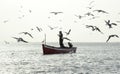 Fisherman using his smartphone while fishing