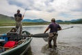 A fisherman with a Taimen Trout on the end of his line in Mongolia, Moron, Mongolia - July 14th 2014 Royalty Free Stock Photo