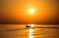A fisherman takes a small local fishing boat out to fish early in the morning at sea, Rayong Province, Thailand