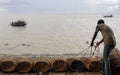 Fisherman taking preparation for fishing by cage and rope on the riverbank