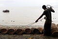 Fisherman taking preparation for fishing by cage and rope on the riverbank