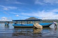 A fisherman from Terunyan village prepares a boat for fishing. A man unleashes a fishing boat on Lake Batur. Mount Batur or Gunung Royalty Free Stock Photo