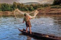 Fisherman throwing a fishing net on the Mekong river in Luang Prabang, Laos