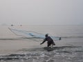 Fisherman is throwing his net