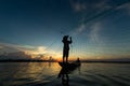 Fisherman throwing net in sunrise , Thailand Royalty Free Stock Photo