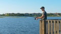 Fisherman cast fishing rod in lake or river water