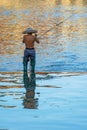 Man catching fish in Fenghuang