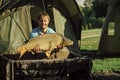 Fisherman with a trophy. Carp fishing, angling, fish catching Royalty Free Stock Photo