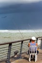 Fisherman watches fishing rods