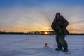 Fisherman winter fishing at dawn Royalty Free Stock Photo