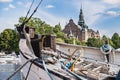 Fisherman wooden boat with ropes mooring in Stockholm Harbour by the Nordiska Museet conveys a feeling of nordic old traditions