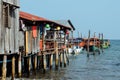 Fisherman wooden boats docked by a pier on pylons