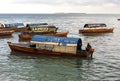 Fisherman and wooden fishing ship in blue water near Zanzibar Is