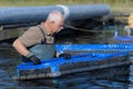 Fisherman working at fishfarm