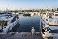 Fisherman among of yachts in Alimos marina in Athens, Greece Royalty Free Stock Photo