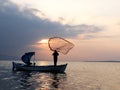 Fishermans throwing net to sea on sunset Royalty Free Stock Photo