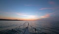 Fishermans view of pink yellow orange sunrise over the Sea of Cortes / Gulf of California while fishing in the early morning