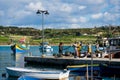 Fishermen back from sea, sorting out their catch and nets on a quay at Marsaxlokk fishing village Royalty Free Stock Photo