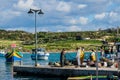 Fishermen back from sea, sorting out their catch and nets on a quay at Marsaxlokk fishing village Royalty Free Stock Photo