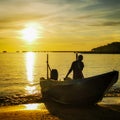 Fishermen with boat at the beach during sunset. Royalty Free Stock Photo
