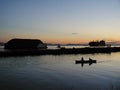 Fishermen in a boat, big container ship and tugboat towing a barge