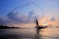 Fishermen on boat fishing with a fishnet,the old traditional equipment of Thai fishery.