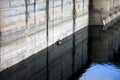 Fishermen in a boat near the Paltinu dam concrete wall, Doftana, Romania