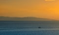 Fishermen boat at sunset in the Mediterranean Sea, near Aegina island, Saronic gulf, Greece Royalty Free Stock Photo