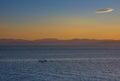 Fishermen boat at sunset in the Mediterranean Sea, near Aegina island, Saronic gulf, Greece Royalty Free Stock Photo