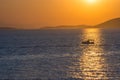 Fishermen boat at sunset in the Mediterranean Sea, near Aegina island, Saronic gulf, Greece Royalty Free Stock Photo