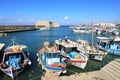 Fishermen boats anchored in harbor by fortress Koules Royalty Free Stock Photo