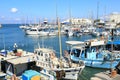 Fishermen boats anchored in harbor by fortress Koules Royalty Free Stock Photo