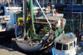 Fishermen boats moored in the dock area inside the ancient port of Genoa. Royalty Free Stock Photo