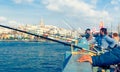 Fishermen catch fish from the Galata bridge in Istanbul