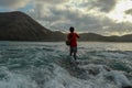 Fishermen catch fish at low tide. View from the back of guy with fishing rods in the water. Close up of Indonesian man Royalty Free Stock Photo