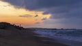 Fishermen catch fish on the seashore at sunset Royalty Free Stock Photo