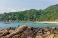 Fishermen catching fish on the rocky tropical beach in Thailand. Sunny day. Stones